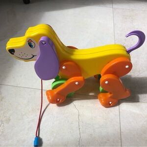 Yellow Plastic Pull-Along Dog Toy with Orange Wheels and Purple Ears